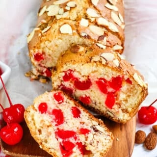 Cherry bread recipe, with loaf sliced and two slices on their side.