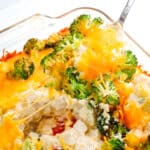 Chicken broccoli potato bake with spoon taking out a serving.