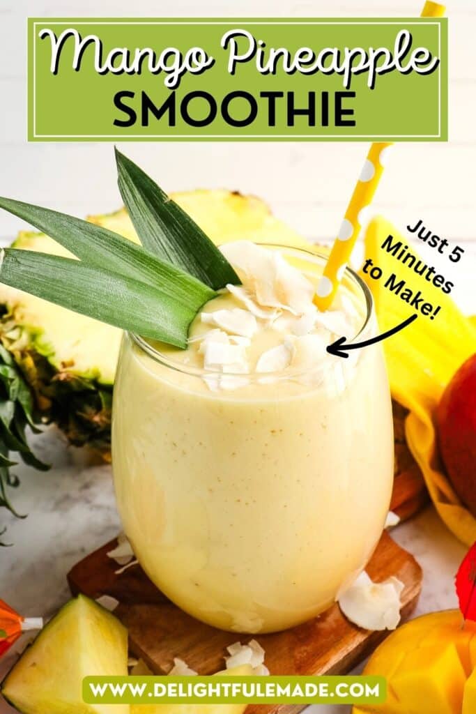 Pineapple mango smoothie in a clear glass topped with coconut flakes, pineapple leaves and a yellow straw.