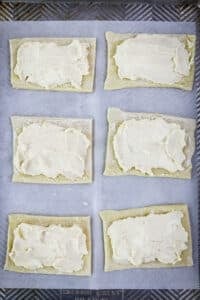 Cream cheese mixture spread over squares of puff pastry for making cream cheese Danish.