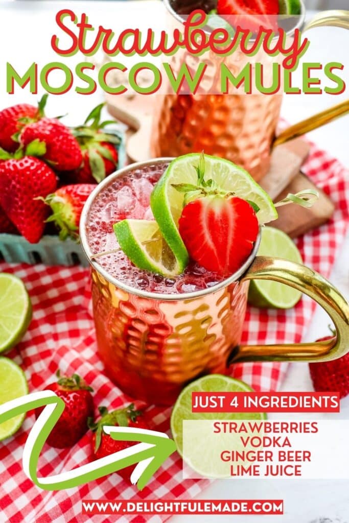 Strawberry Moscow mules in copper mugs topped with fresh strawberries and lime slices.