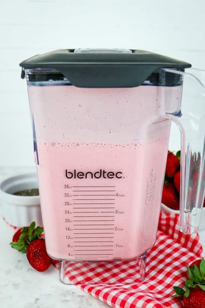 Strawberry mixture in a blender jar after being blended.