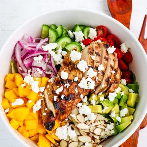 Chicken and mango salad topped with grilled chicken and goat cheese crumbles.