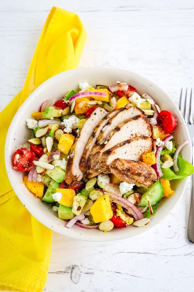 Chicken and mango salad topped with grilled chicken and goat cheese crumbles.