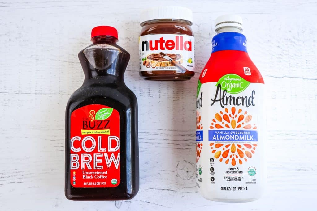 Ingredients needed to make Nutella coffee; cold brew coffee, Nutella spread and almond milk.