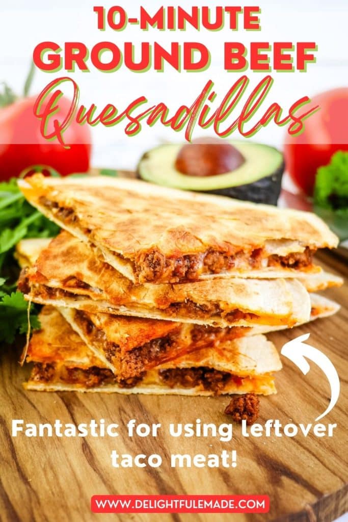 A stack of four ground beef quesadilla tacos with tomatoes and avocado in the background.