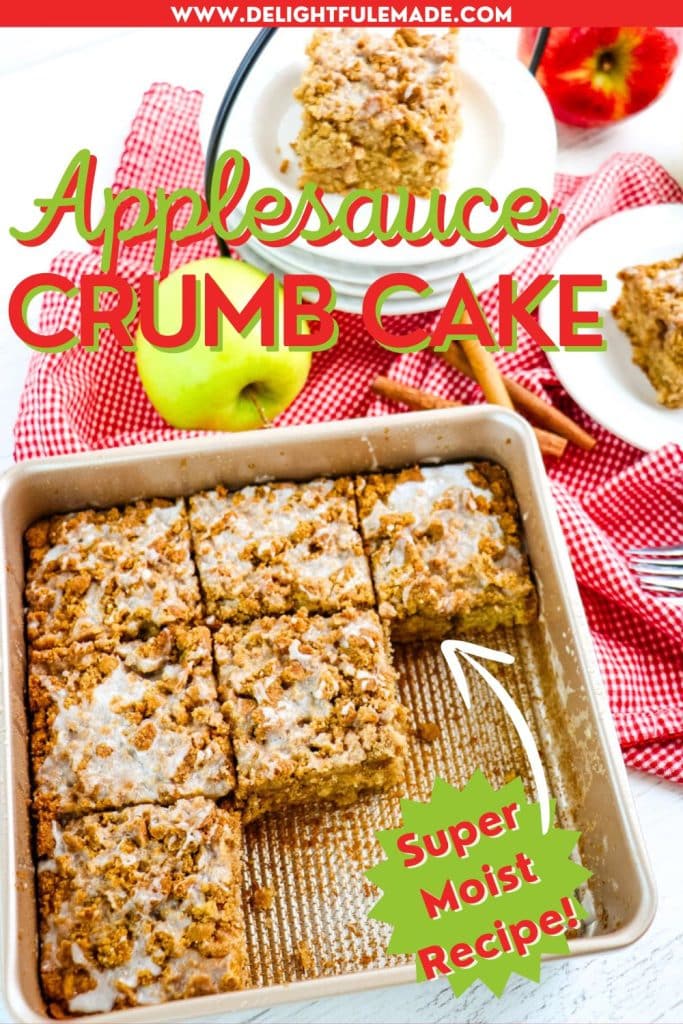 Square pan of sliced applesauce crumb cake cut into squares, with two cake squares on white plates, with green apple on the side.