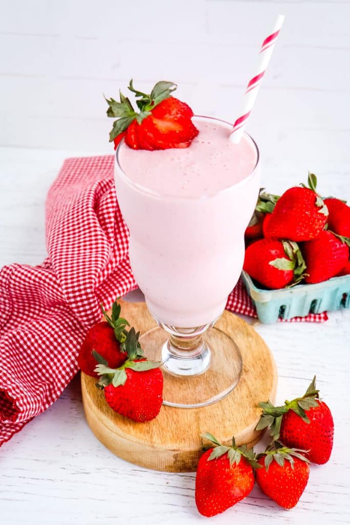 Cottage cheese fruit smoothie with strawberries on the side.