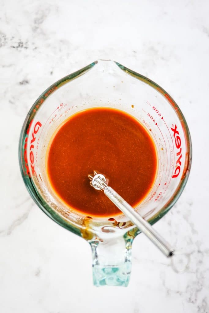 Stir fry sauce in a glass measuring cup that has been whisked together.