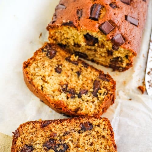 Chocolate chunk banana bread slices with two slices on their side.
