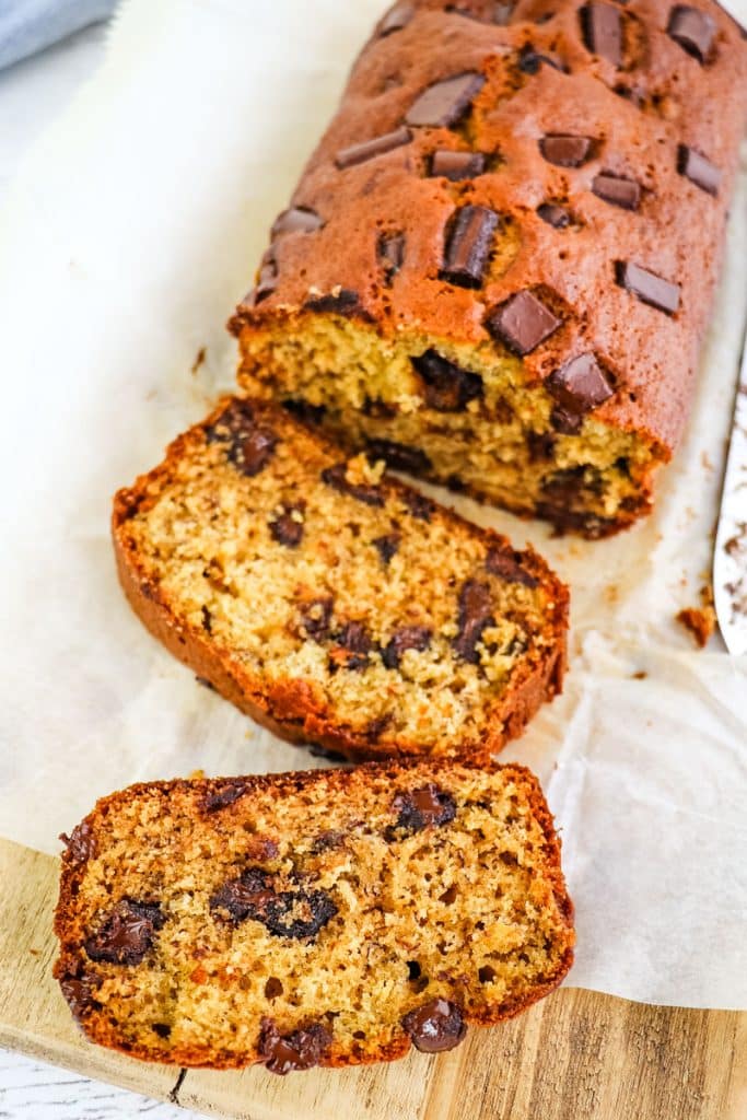 Chocolate chunk banana bread slices with two slices on their side.