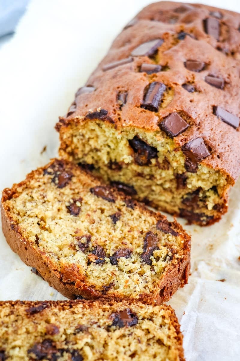 Chocolate chunk banana bread that has been sliced, showing the chocolate chunks on the inside.