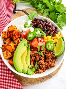 Sweet potato taco bowl with ground beef, cottage cheese, beans and avocado.