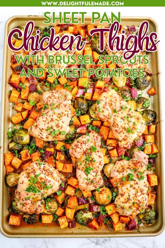 Sheet pan with maple dijon chicken thighs and sweet potatoes with brussels sprouts, all topped with chopped parsley.