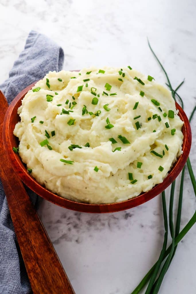 Boursin mashed potatoes with fresh chives on top.