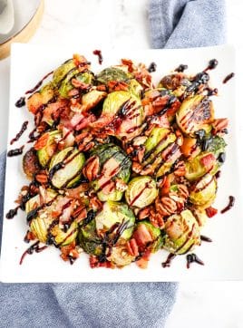 Roasted Brussels sprouts with bacon and balsamic vinegar glaze and topped with pecans.