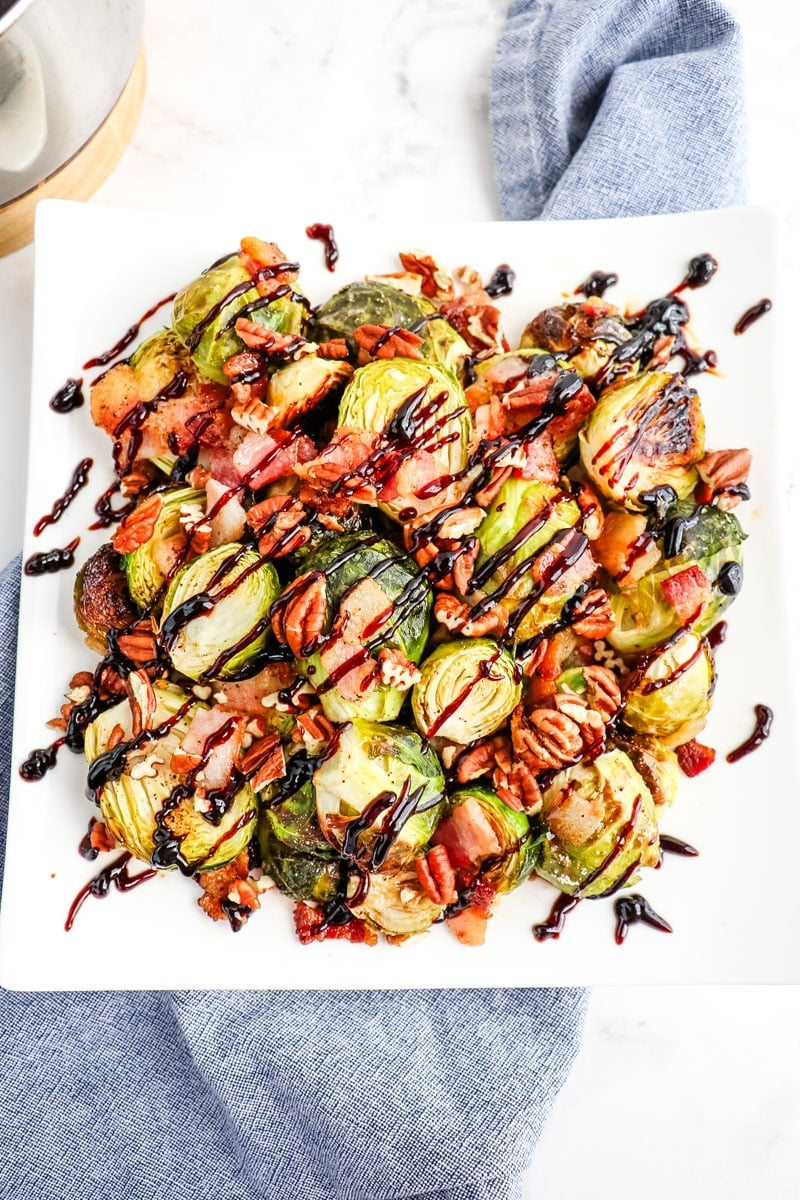 Roasted Brussels sprouts with bacon and balsamic vinegar glaze and topped with pecans.