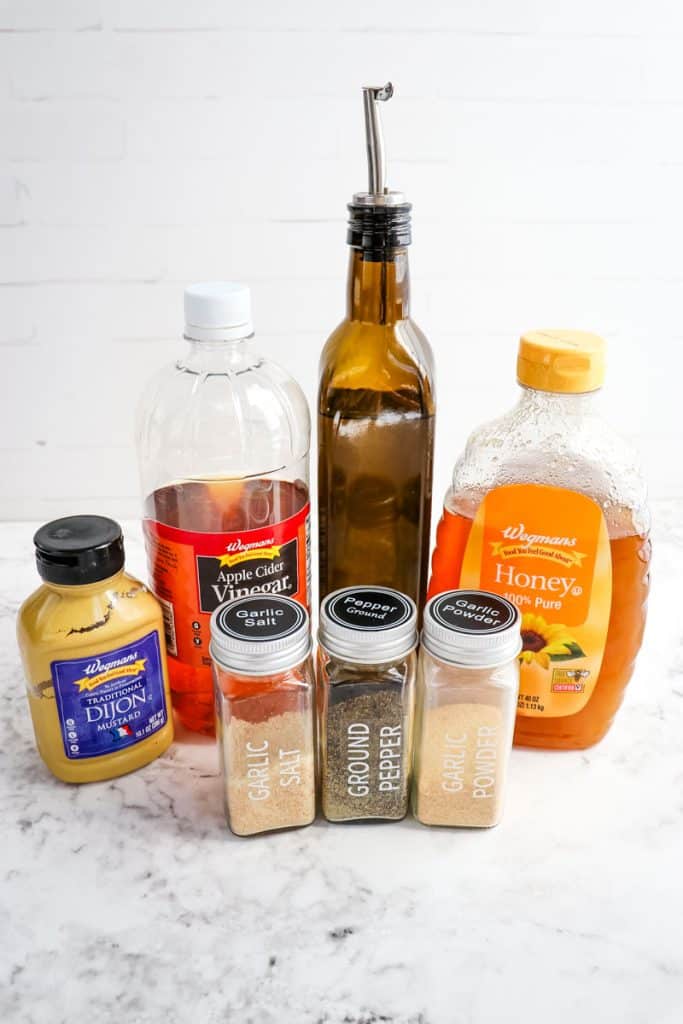 Ingredients needed to make a honey Dijon salad dressing.