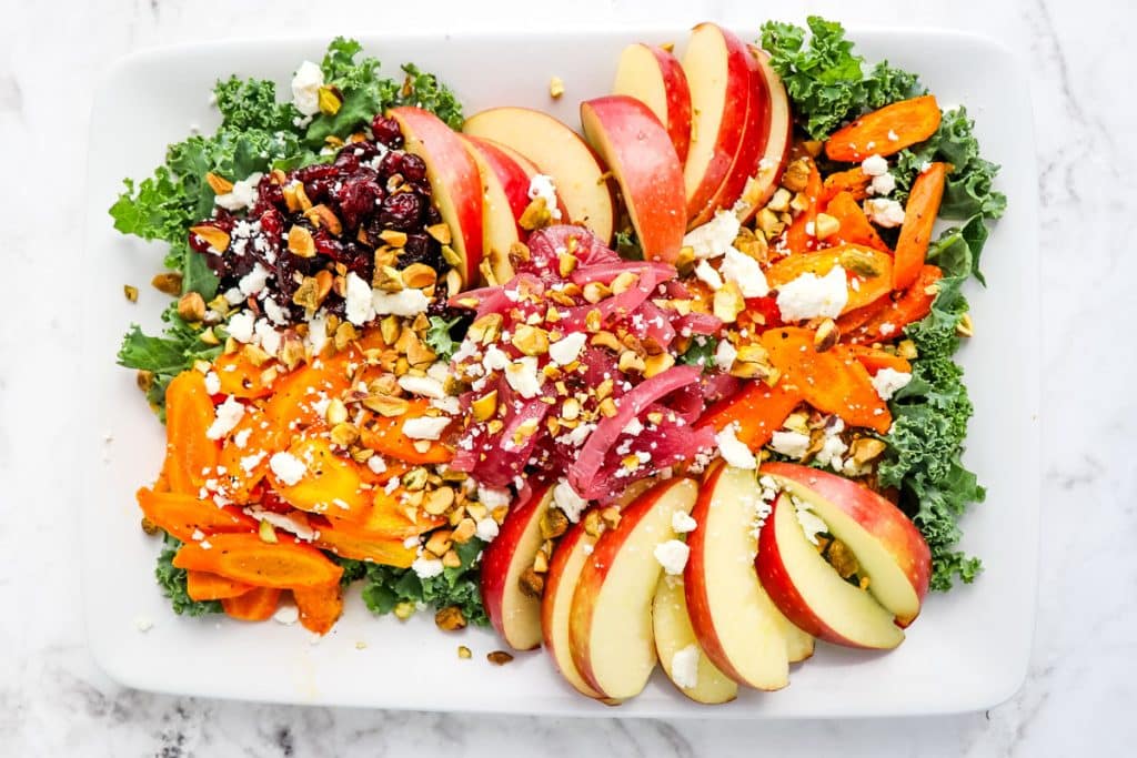 Roasted carrot salad with kale, sliced apples, cranberries and pistachios.