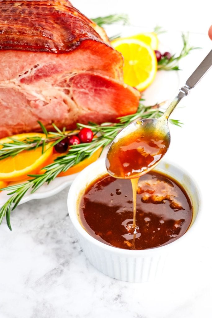 Orange glaze in small serving dish to be served on the side of the spiral ham.