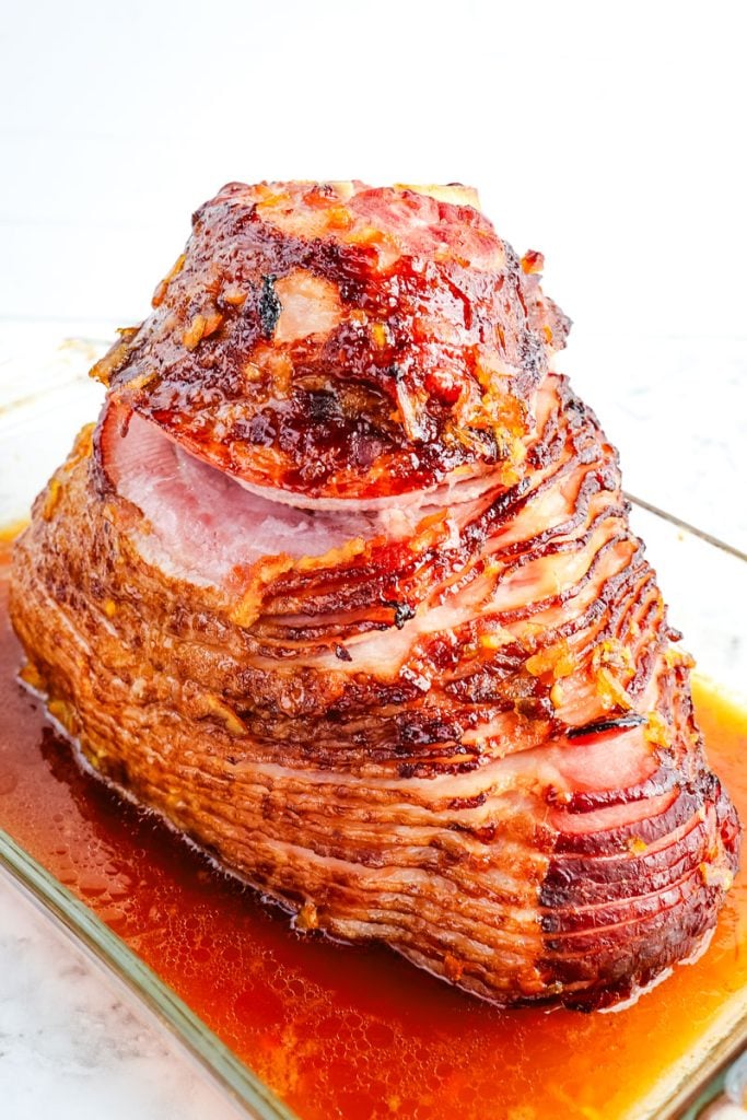 Orange glazed ham after being baked in the oven.