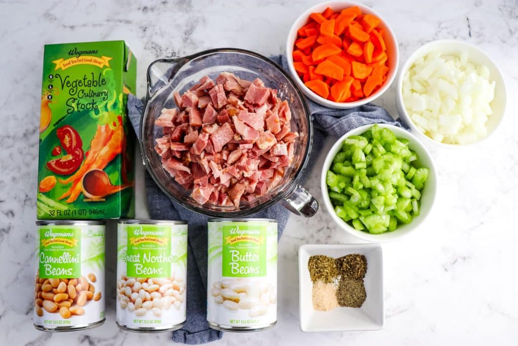 Ingredients needed to make ham and bean soup in a slow cooker.