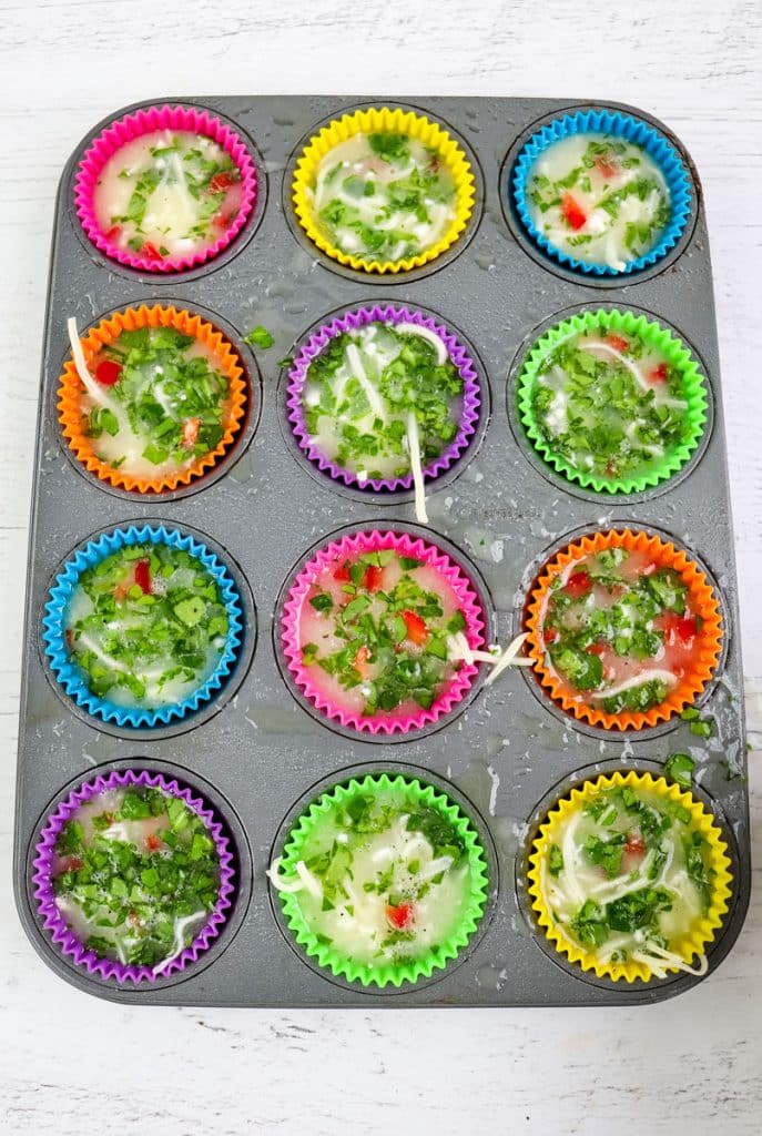Egg white bites in silcone baking cups before going into the oven to bake.