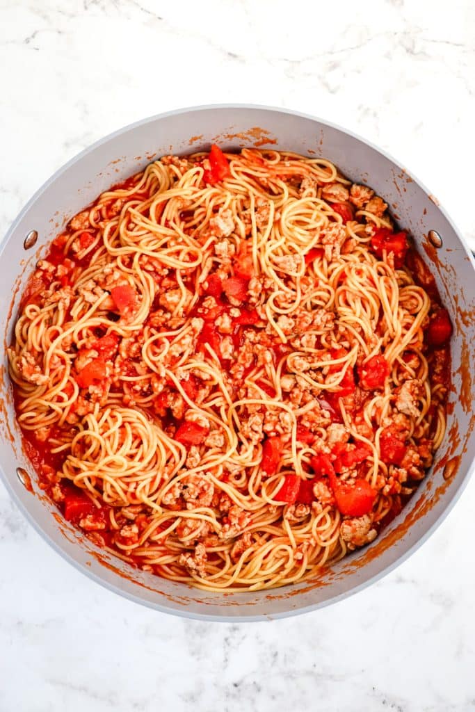 Ground turkey and spaghetti in red sauce with diced tomatoes.
