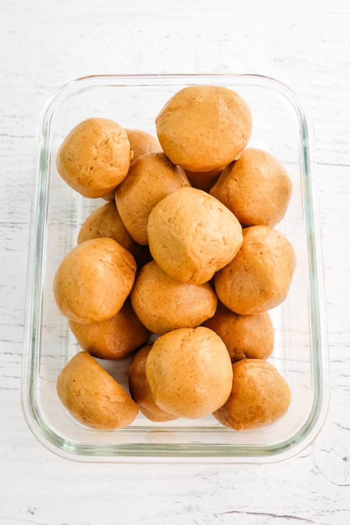 Peanut butter protein balls in a glass meal prep container.