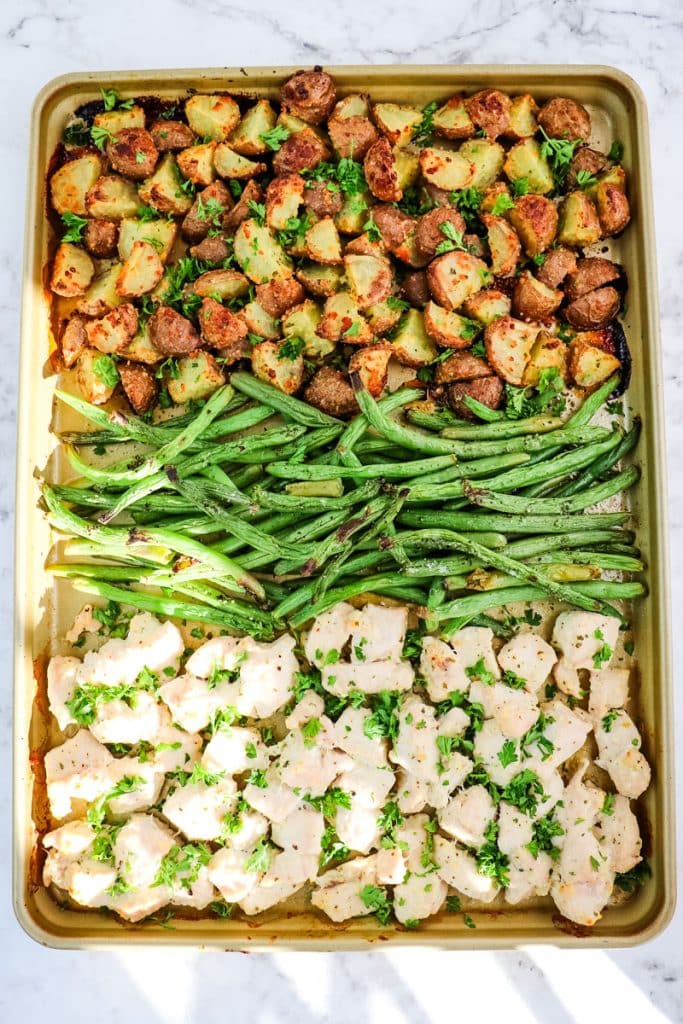 Sheet pan ranch chicken, potatoes and green beans that have been roasted in the oven.