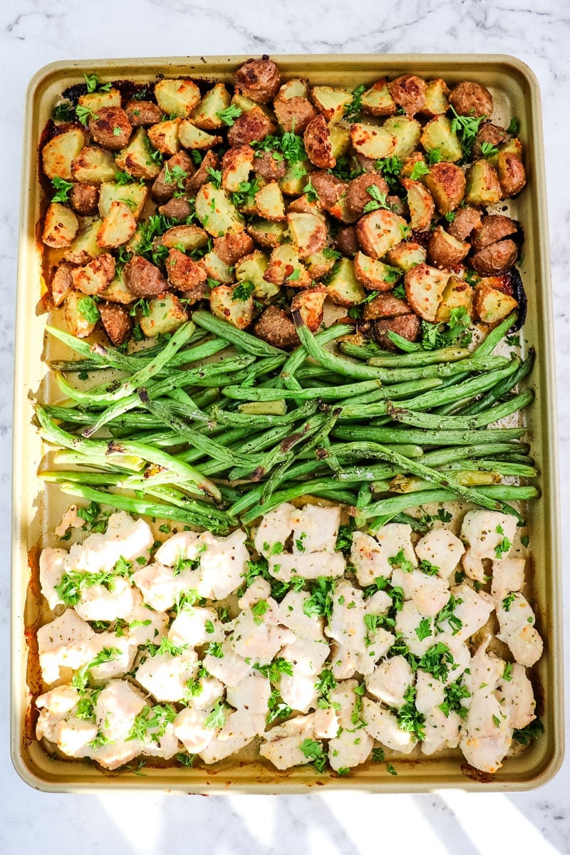 Sheet pan ranch chicken, potatoes and green beans that have been roasted in the oven.